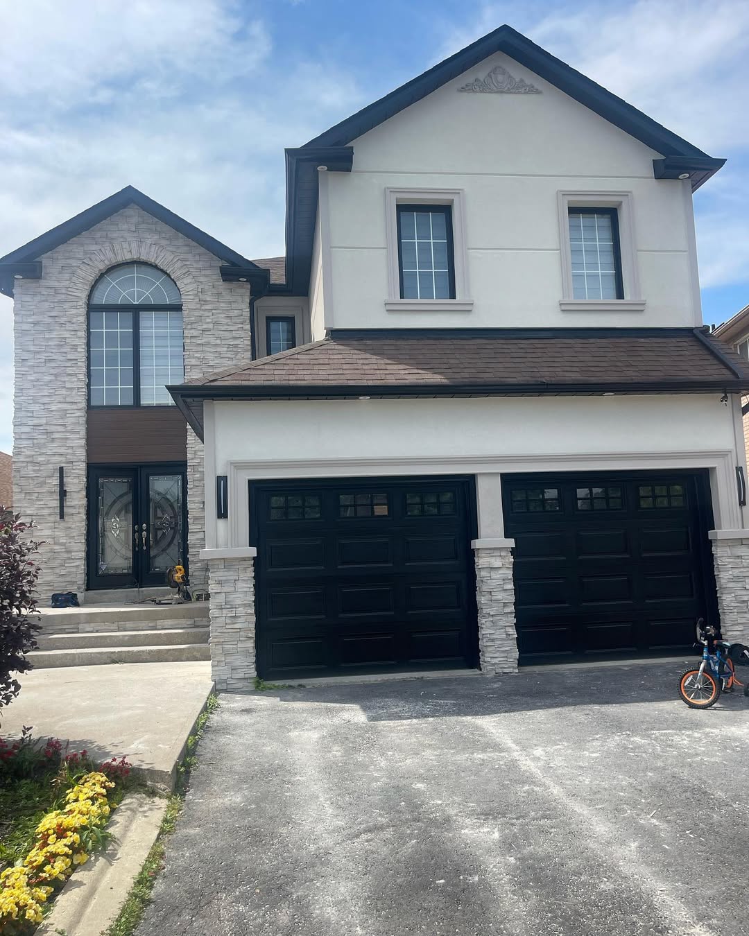 Large stucco home with double garage and arched windows