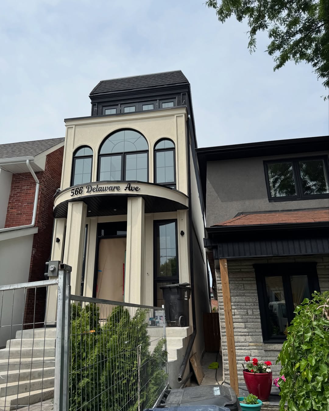 Stucco townhouse exterior with arched windows and columns