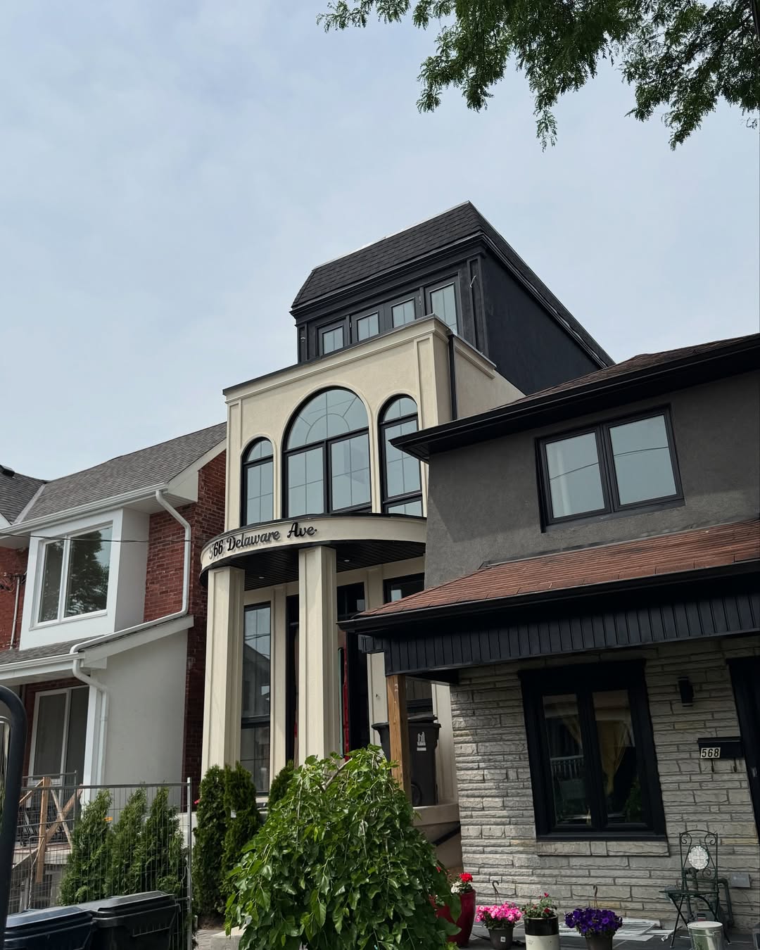 Stucco and brick townhouse with black trim details
