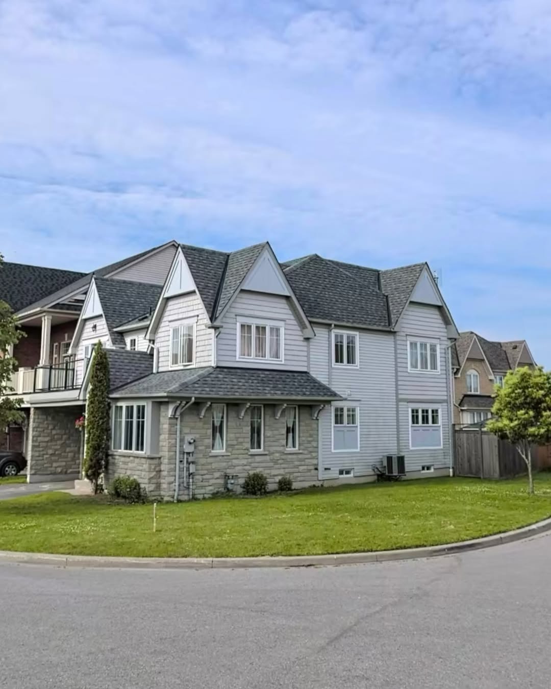 Large residential home with new exterior siding in grey