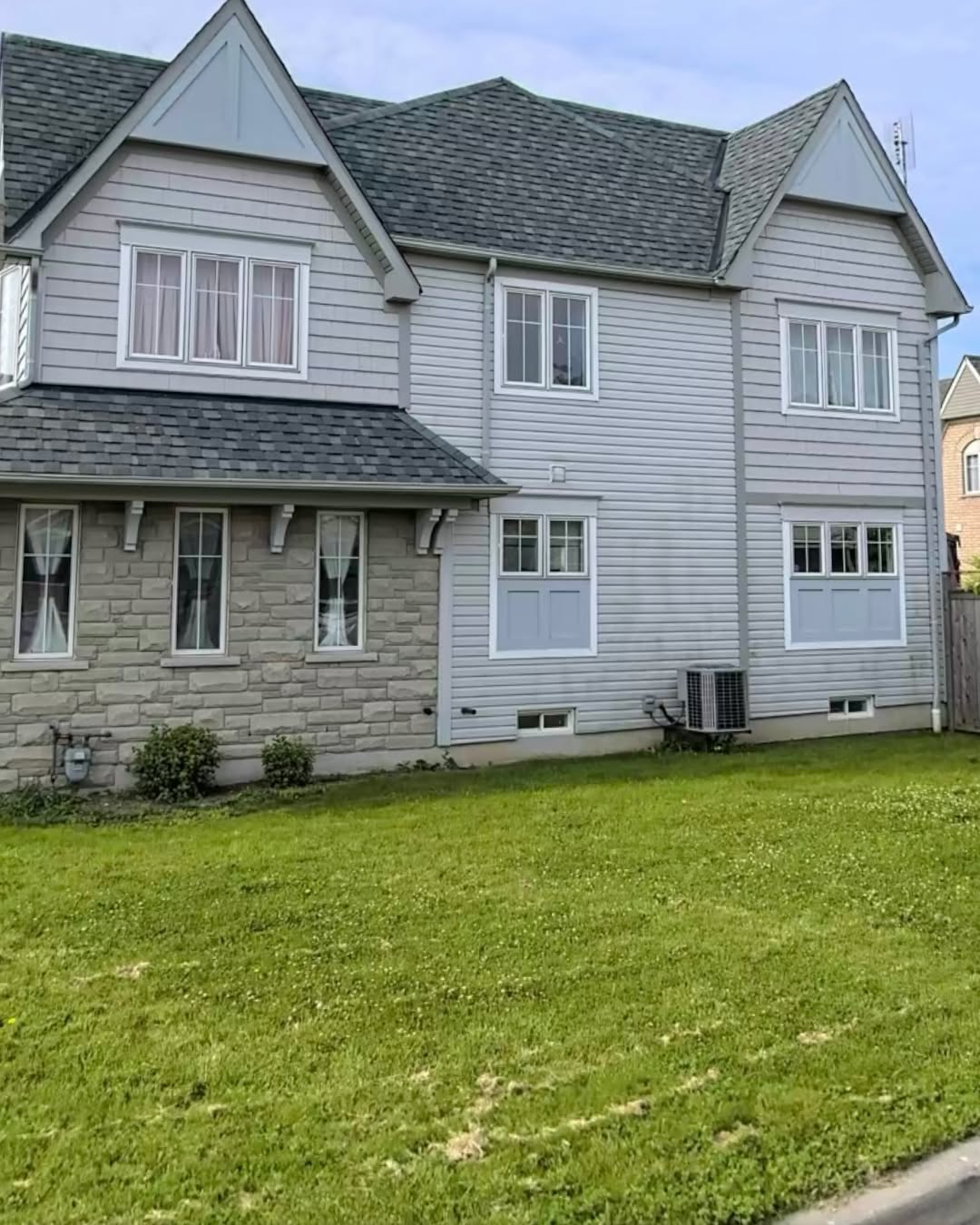 Backyard view of home with new grey siding installed