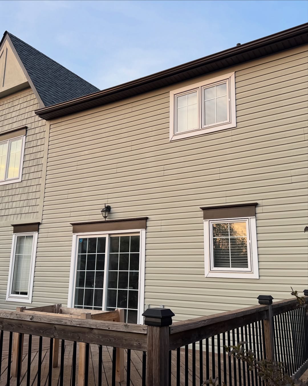 Home exterior with new siding and deck railing