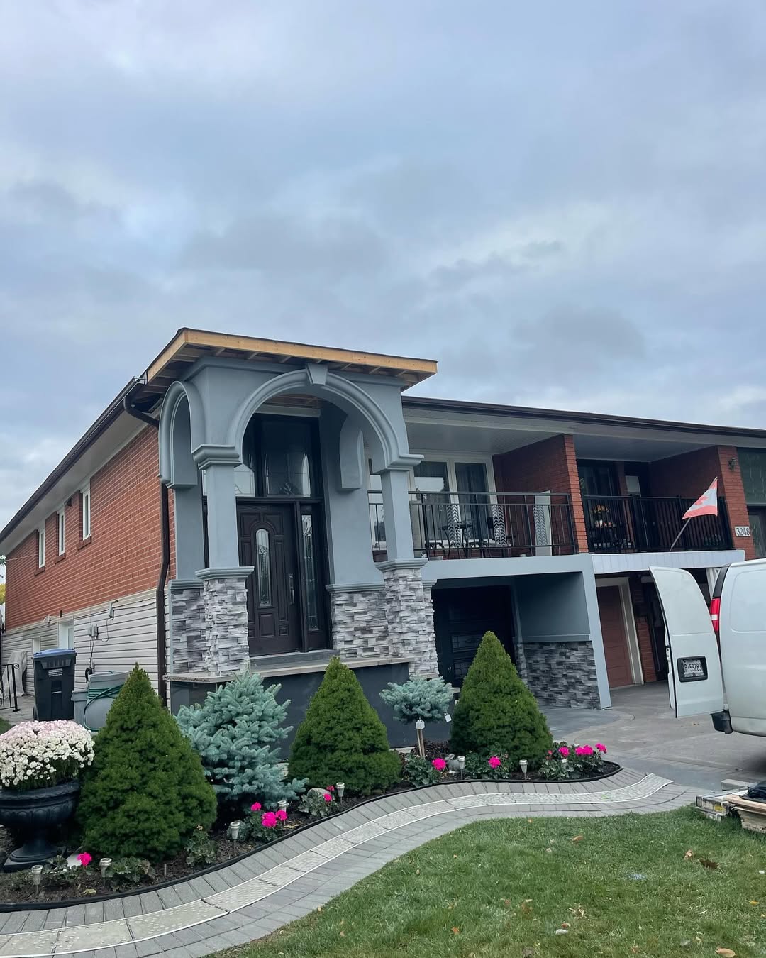 Stucco and brick home with landscaped front yard