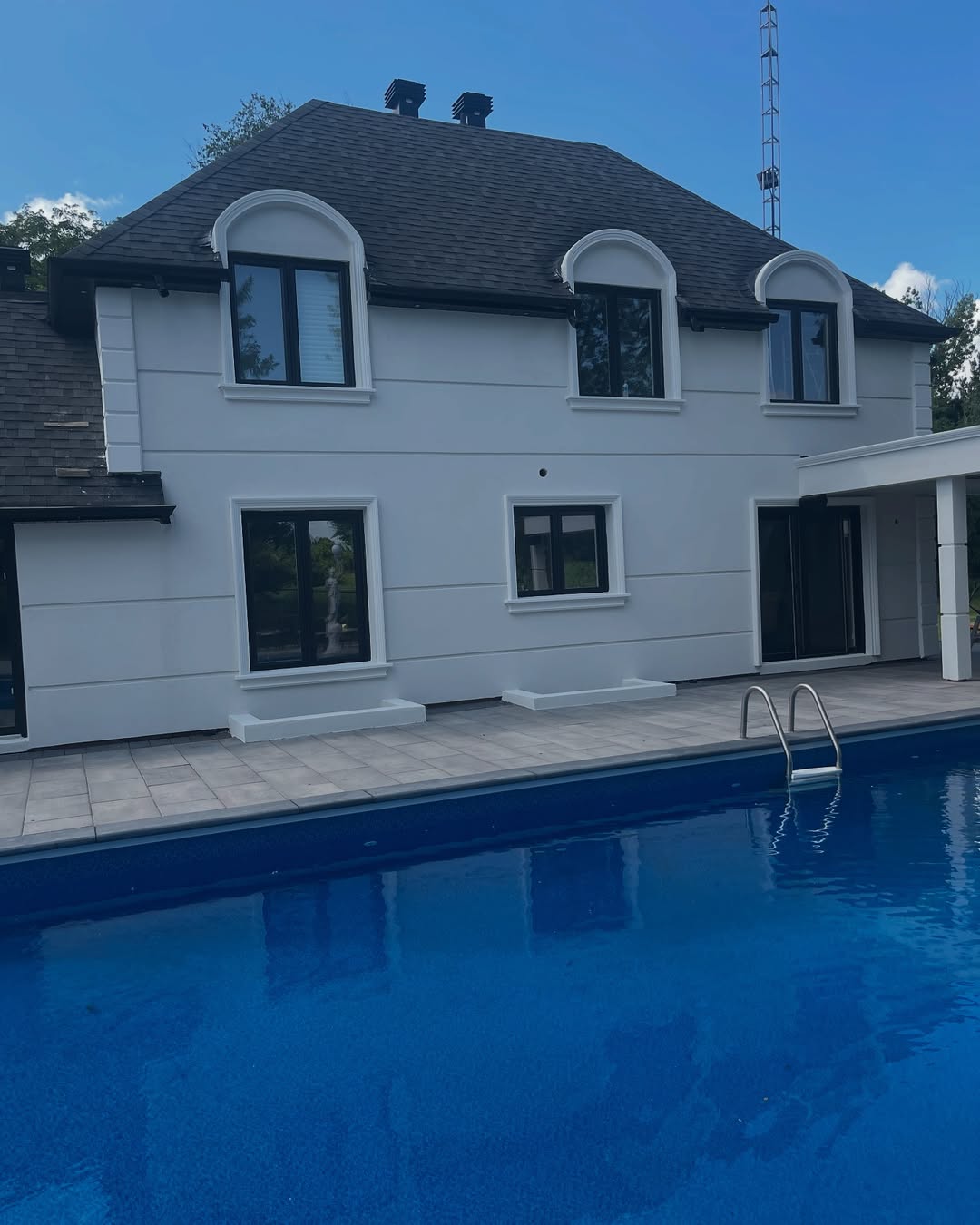 Luxury home with white stucco exterior and swimming pool