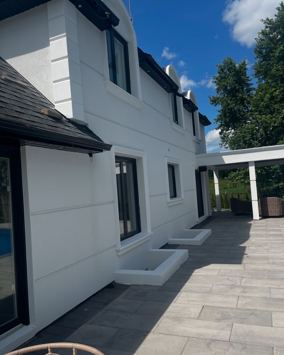 White stucco home exterior with black window frames