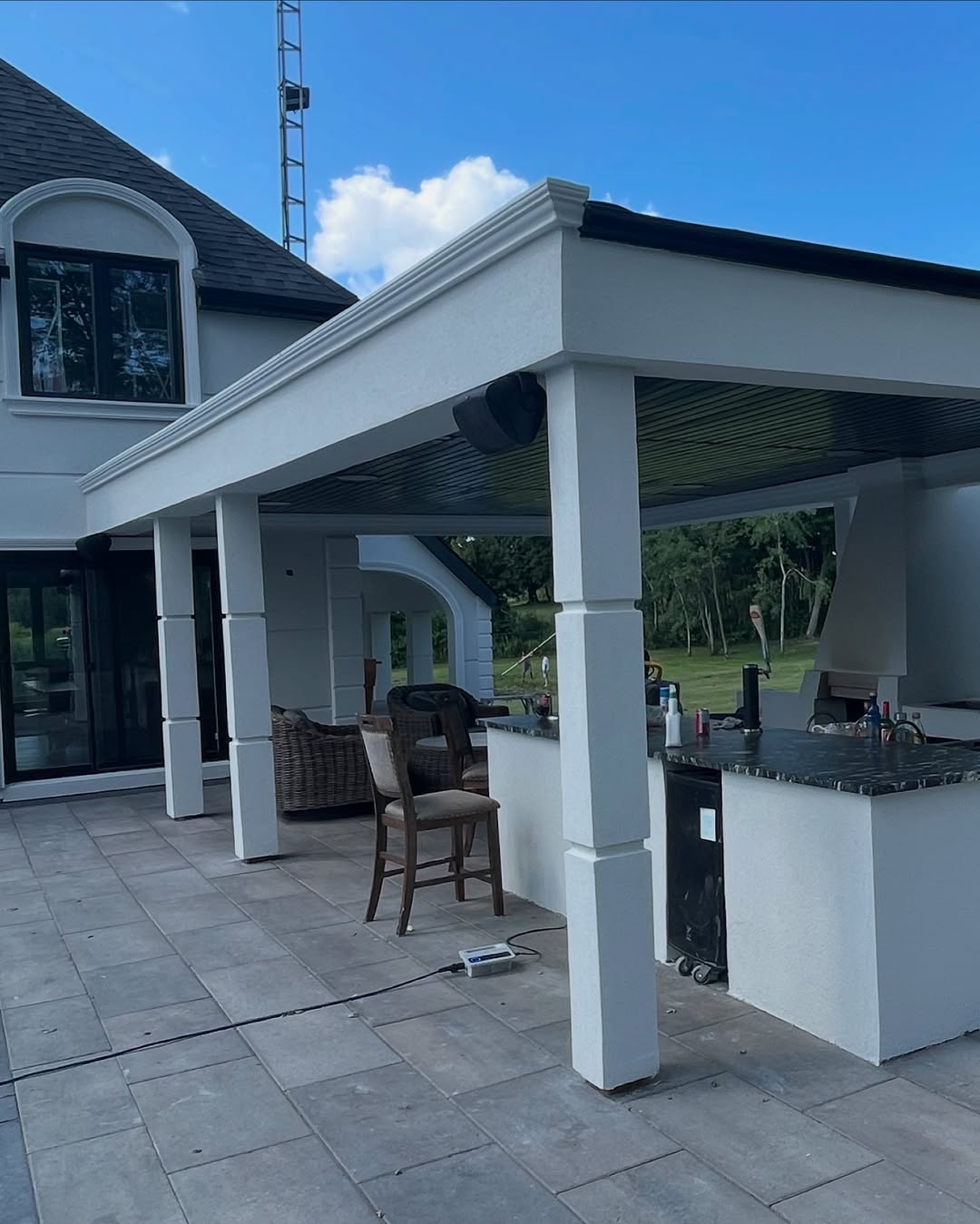White stucco home with covered patio and columns