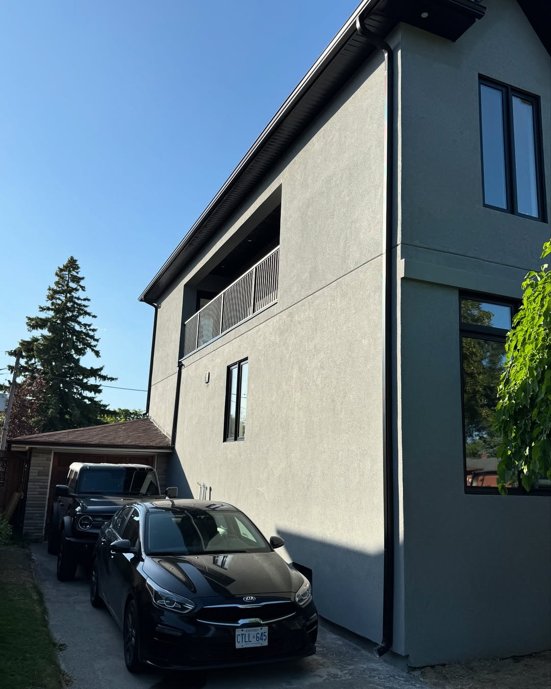 Side view of stucco home exterior with white finish