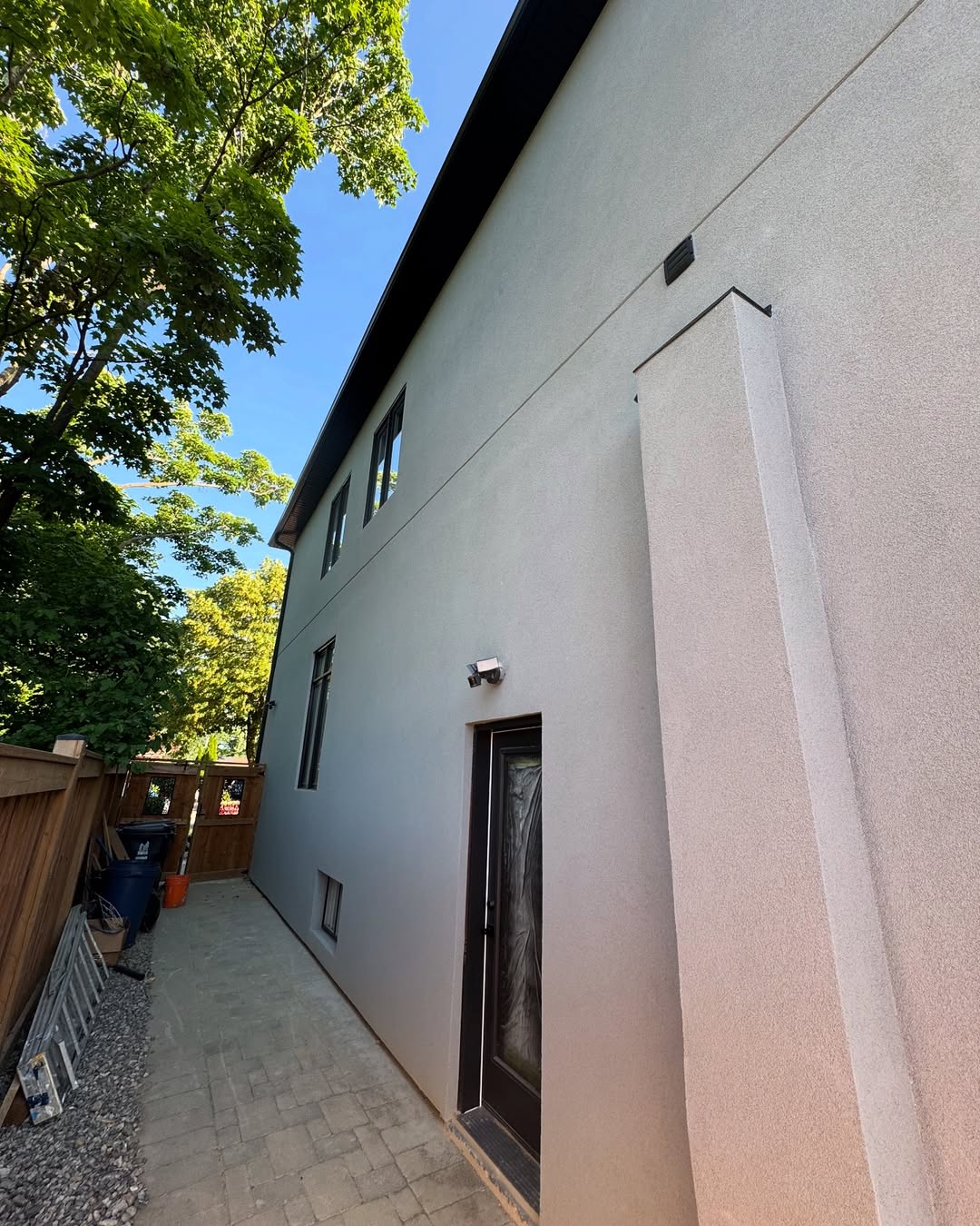 Narrow side passage with fresh white stucco walls